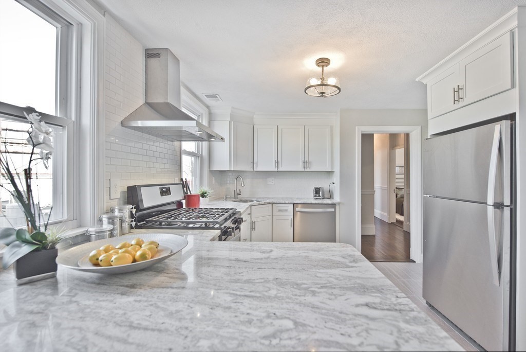 a kitchen with refrigerator and cabinets