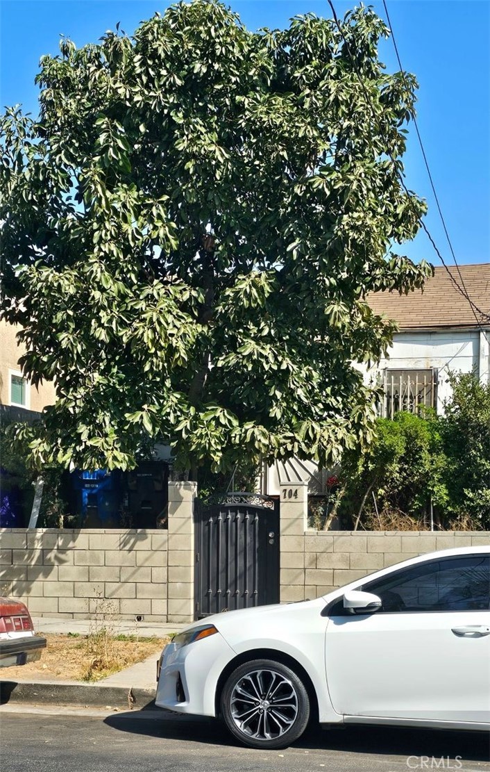 a view of street with a car parked on the road