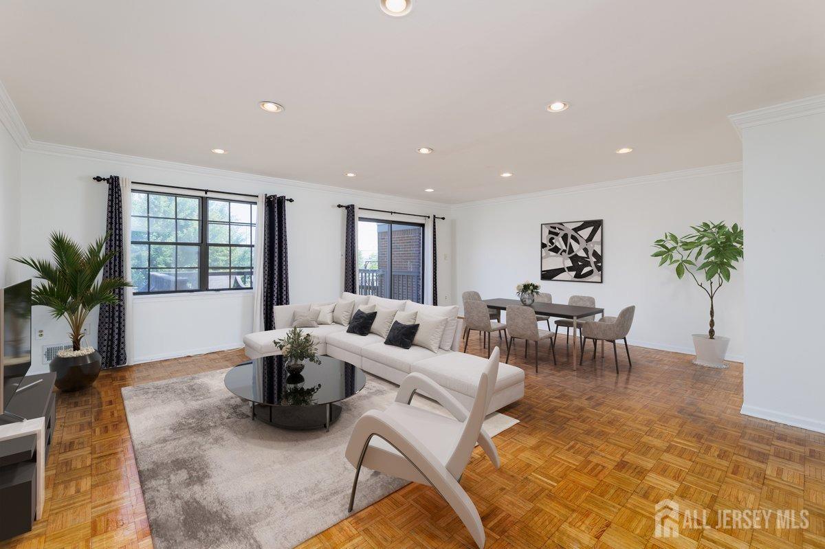 a living room with furniture large window and potted plants