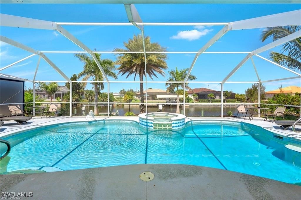 a view of a backyard with table and chairs under an umbrella