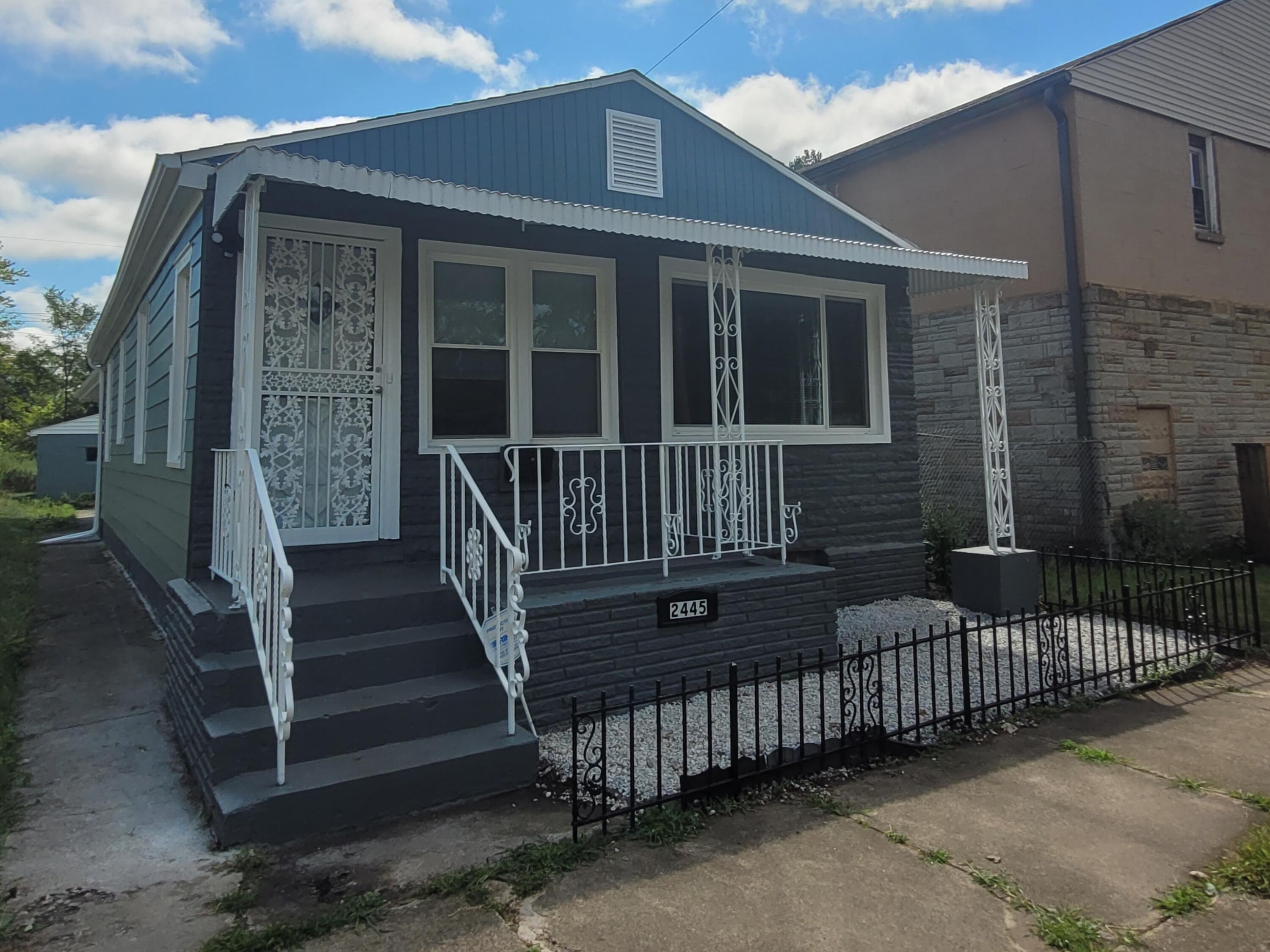 a view of a house with wooden fence