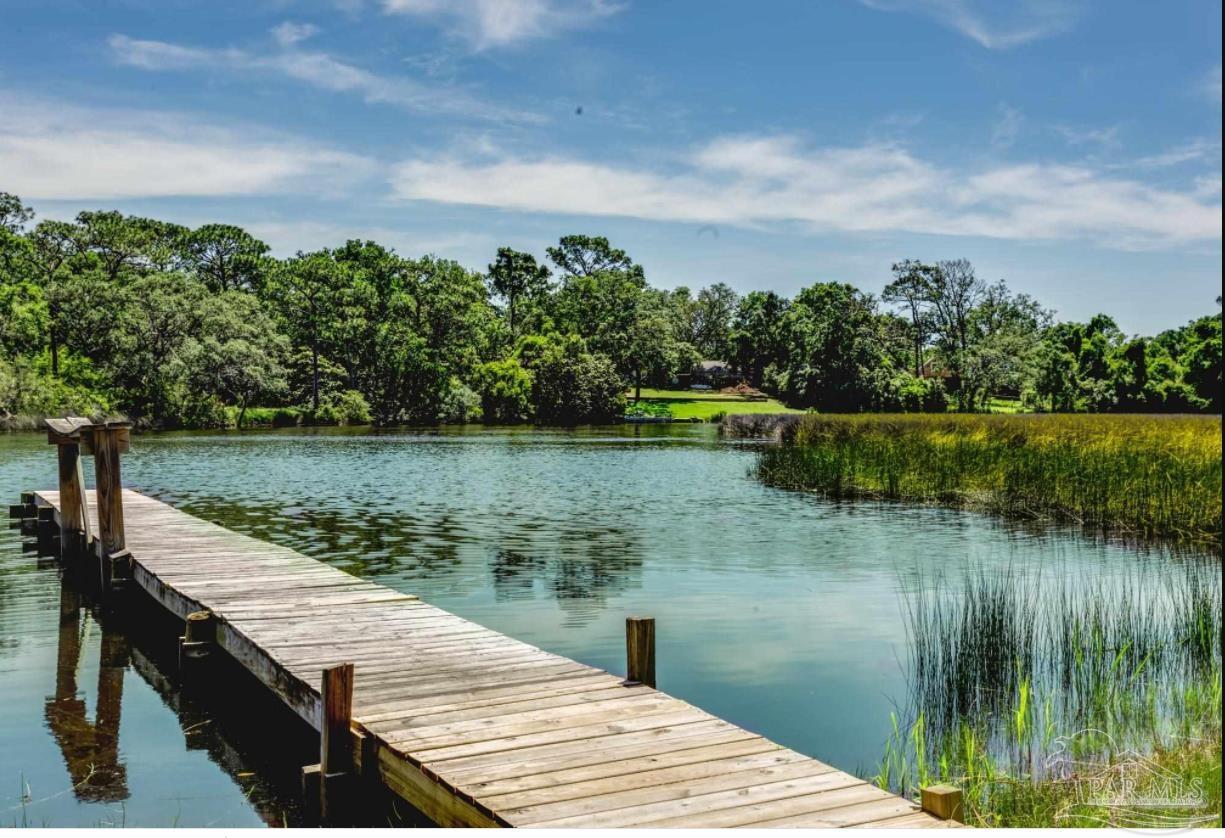 a view of a lake with a wooden floor and lake view