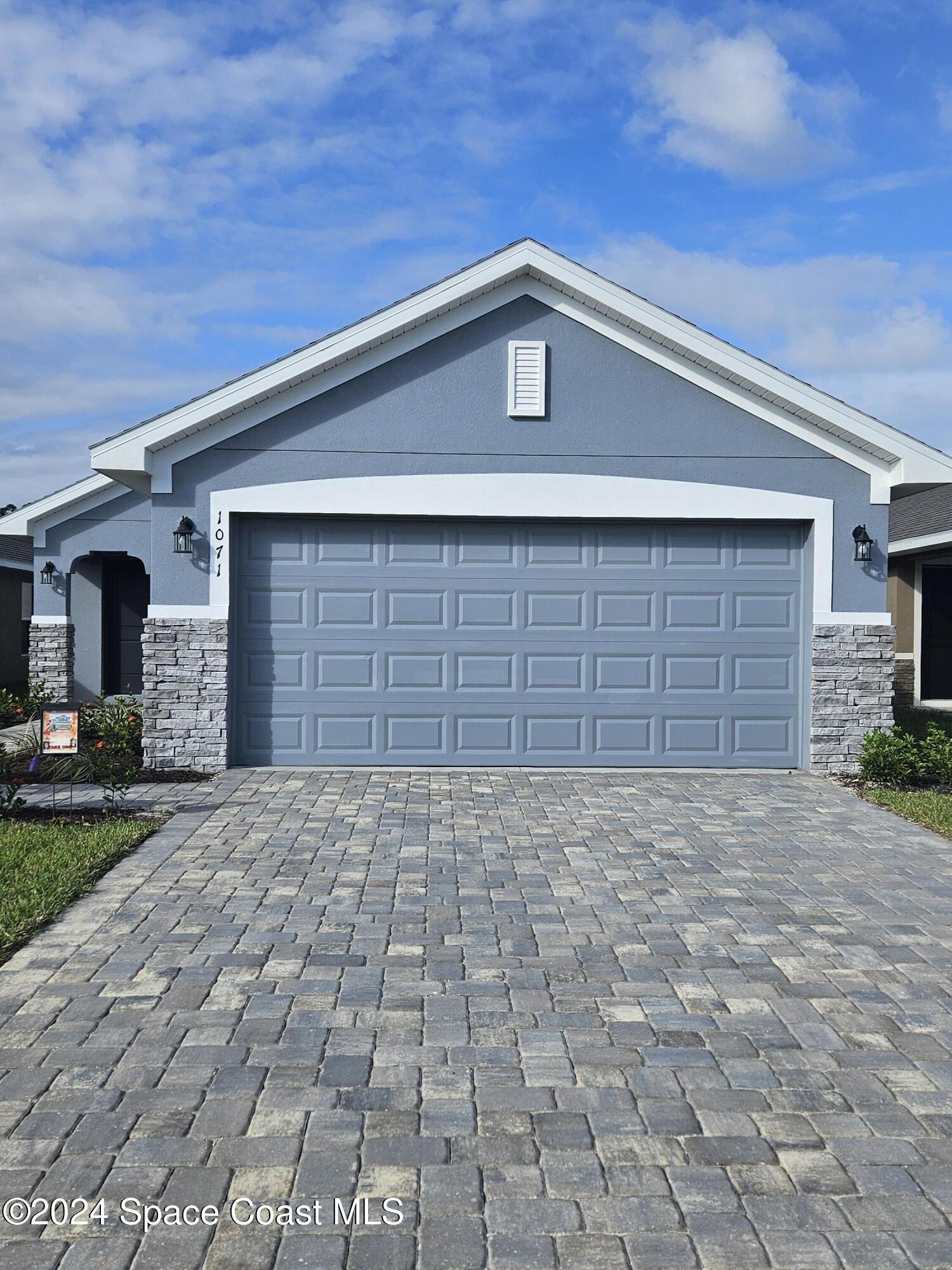 a front view of a house with a garage