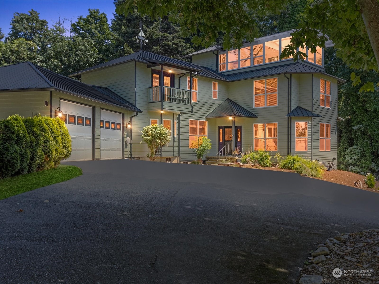 a front view of a house with a garden and parking