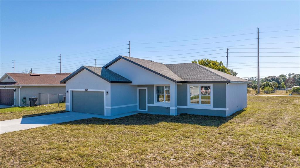 a house that has a wooden fence and a yard