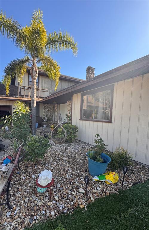 a view of a backyard with plants and a garden