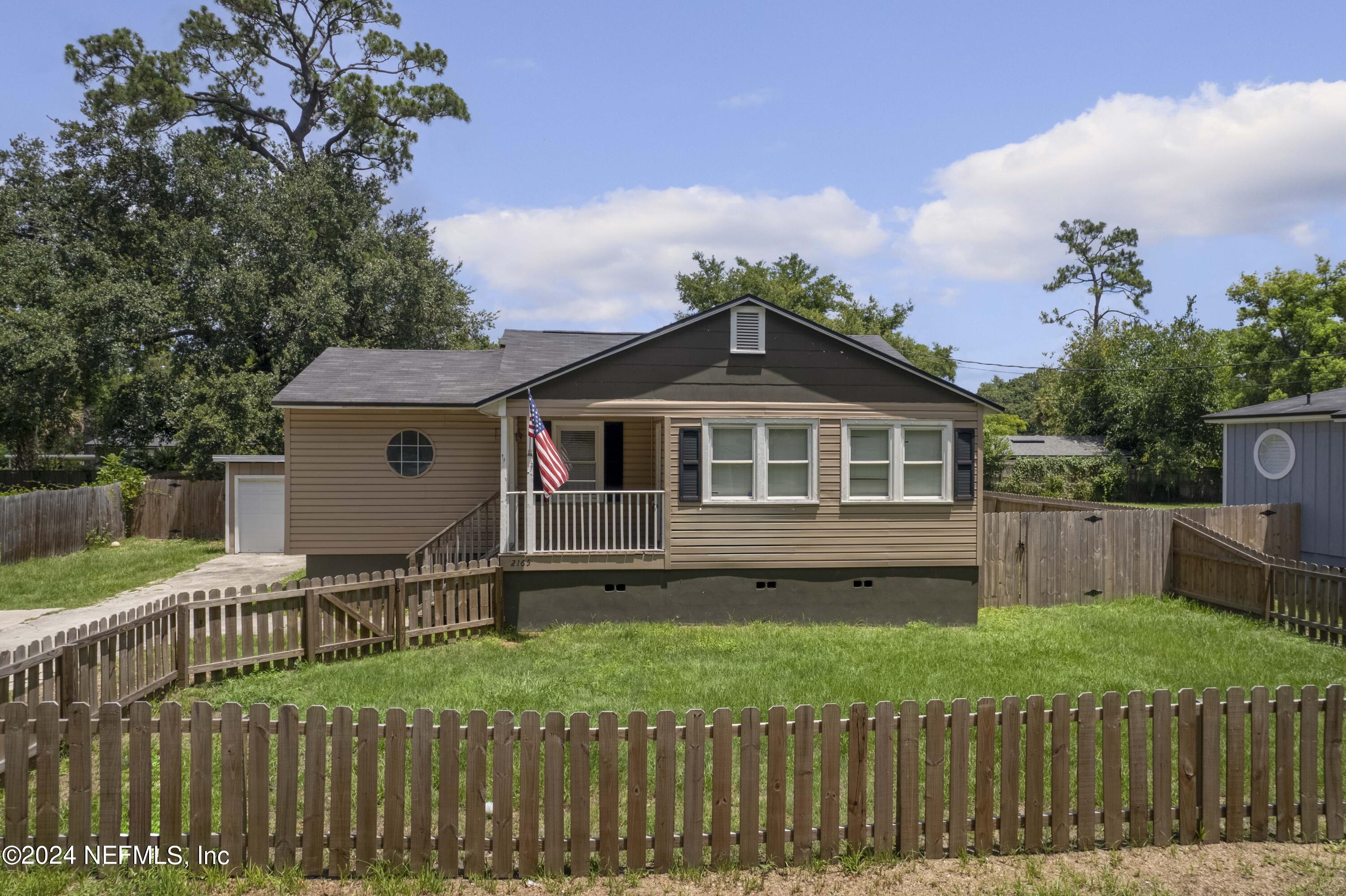 a front view of house with yard and green space