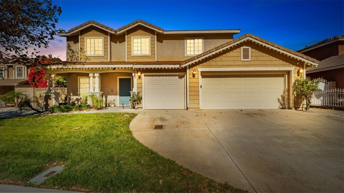 a front view of a house with a yard and garage