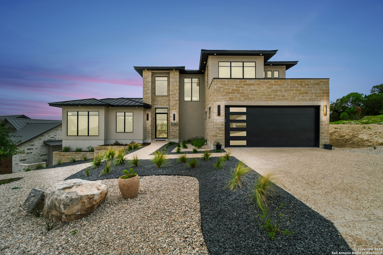 a front view of a house with a yard and garage