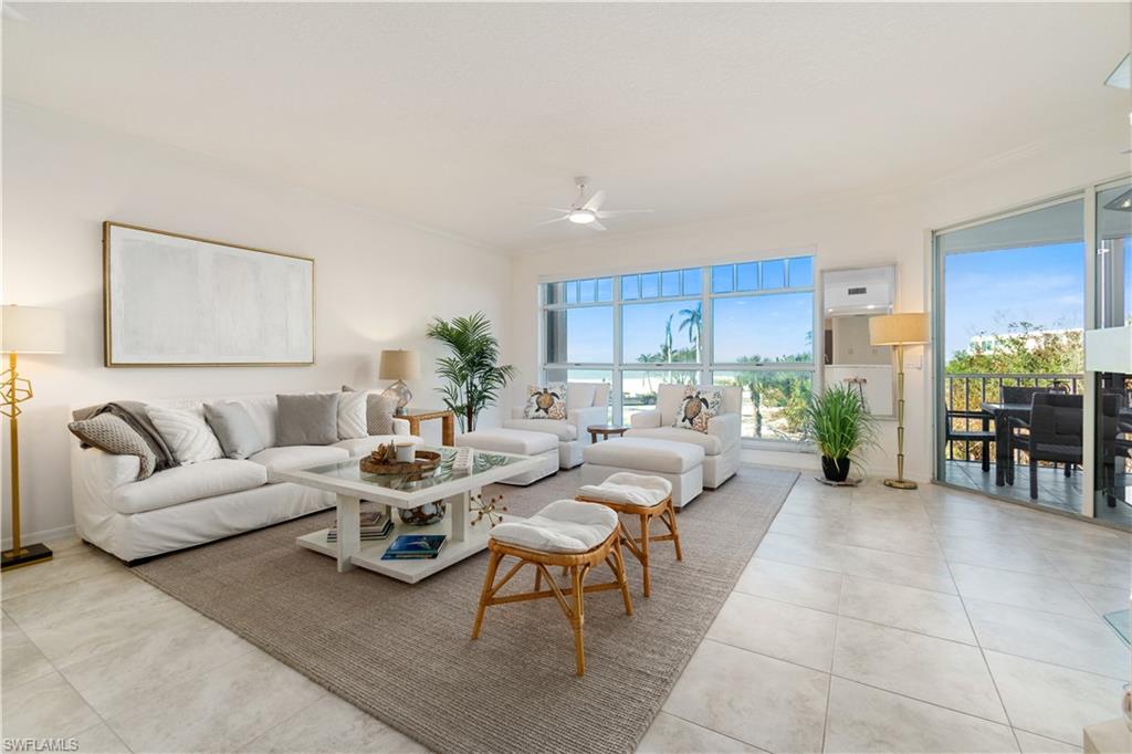 a living room with furniture and a dining table with kitchen view