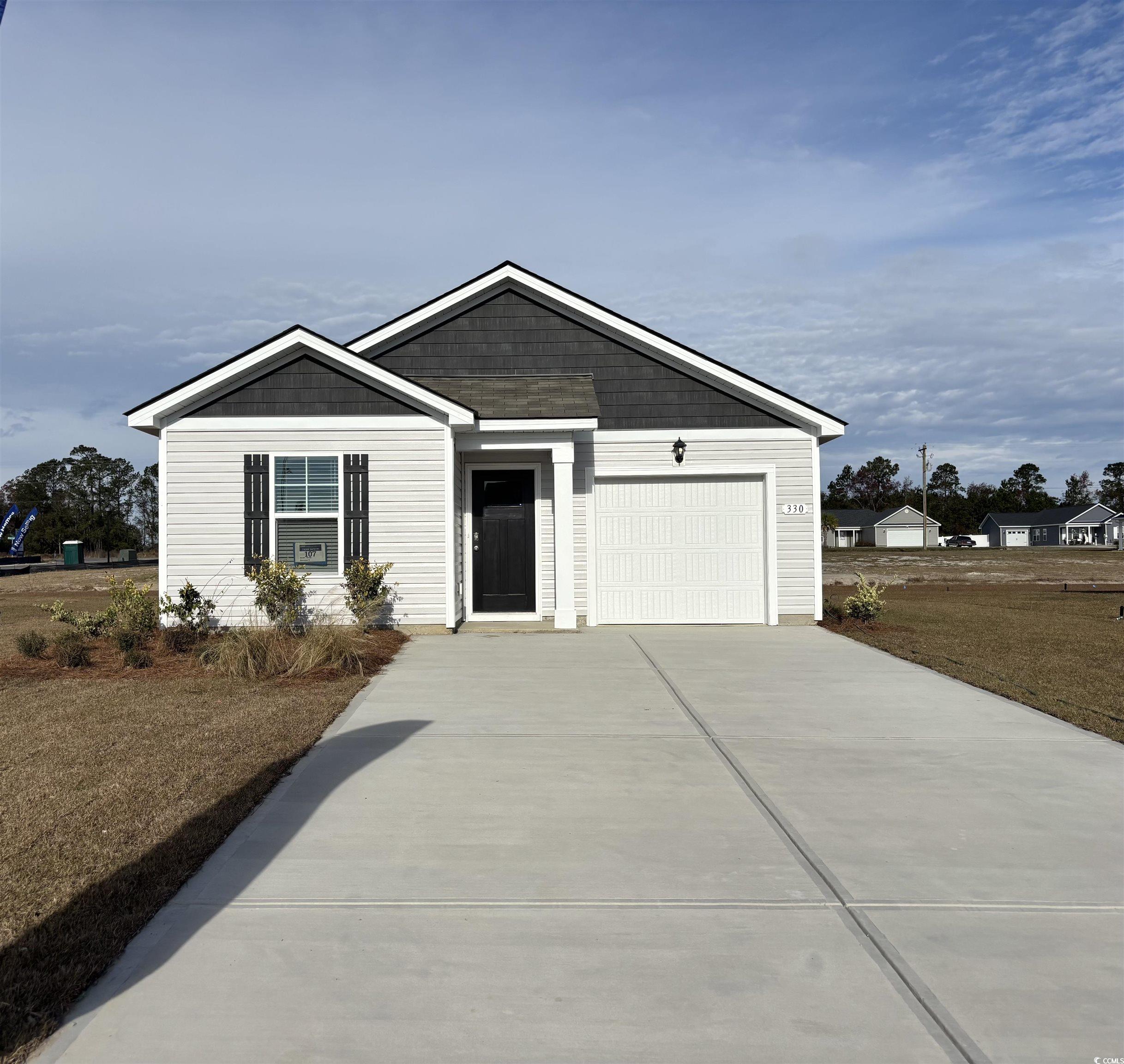 View of front facade featuring a garage