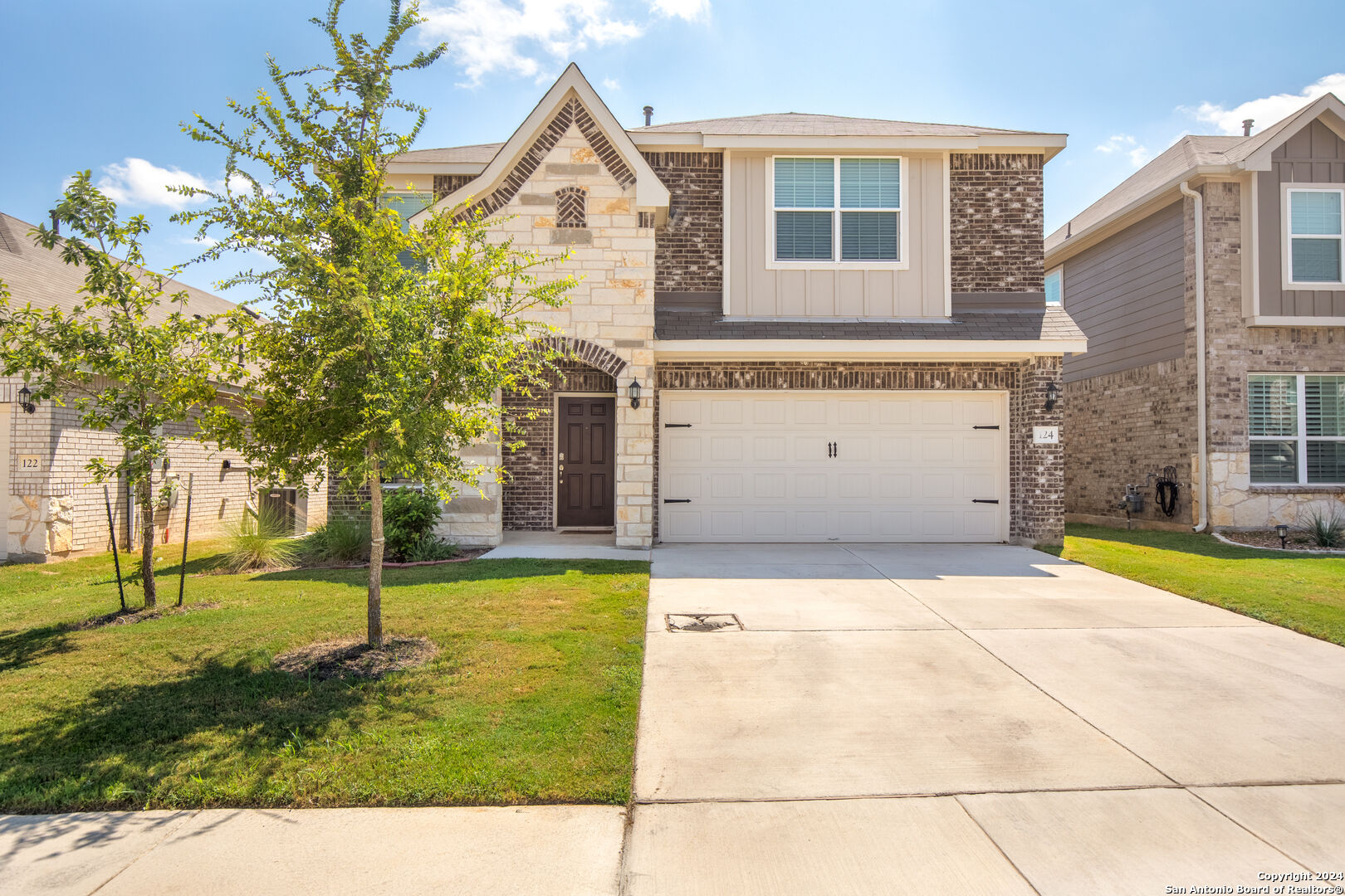 a front view of a house with a yard