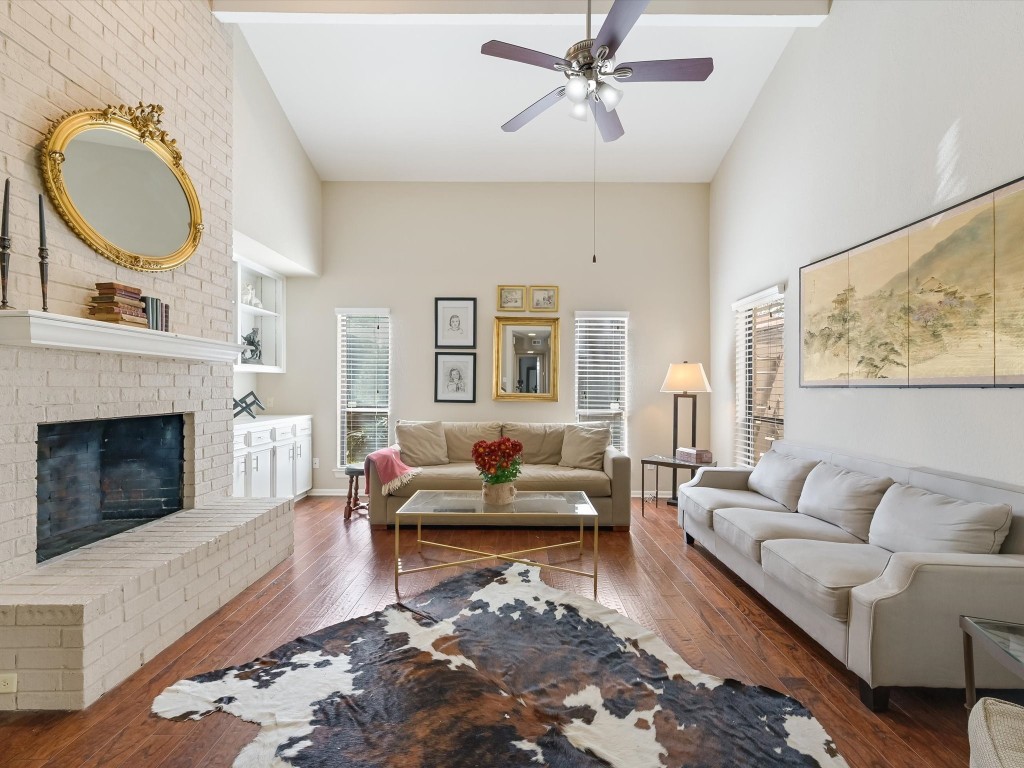 a living room with furniture a fireplace and window