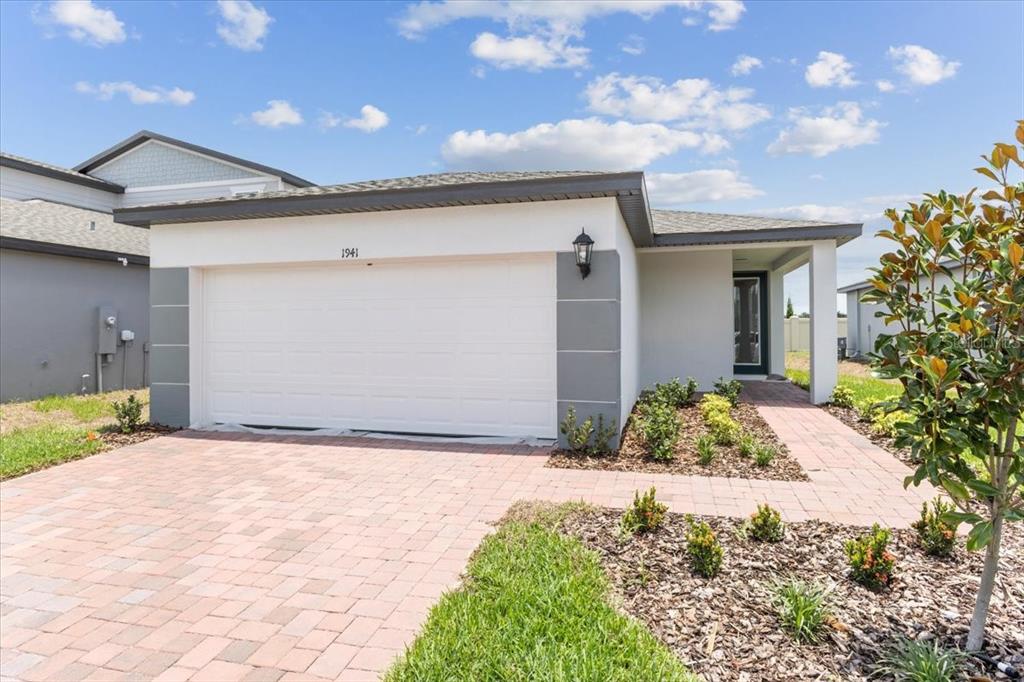 a front view of a house with a yard and garage