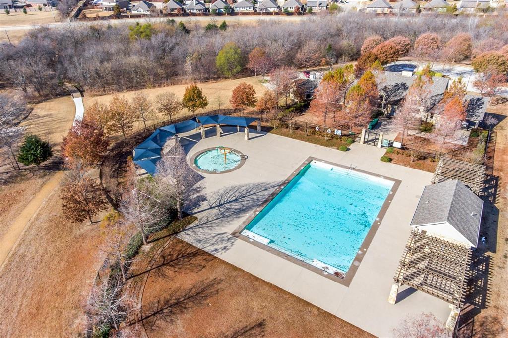 an aerial view of a house with a yard and lake view