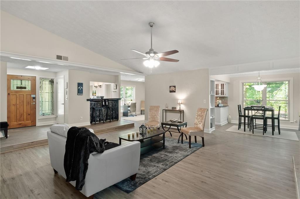 a living room with furniture and wooden floor