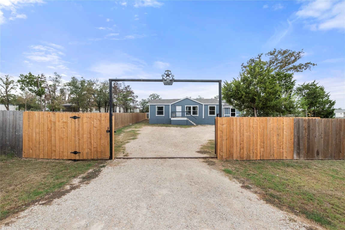 a view of a house with wooden fence