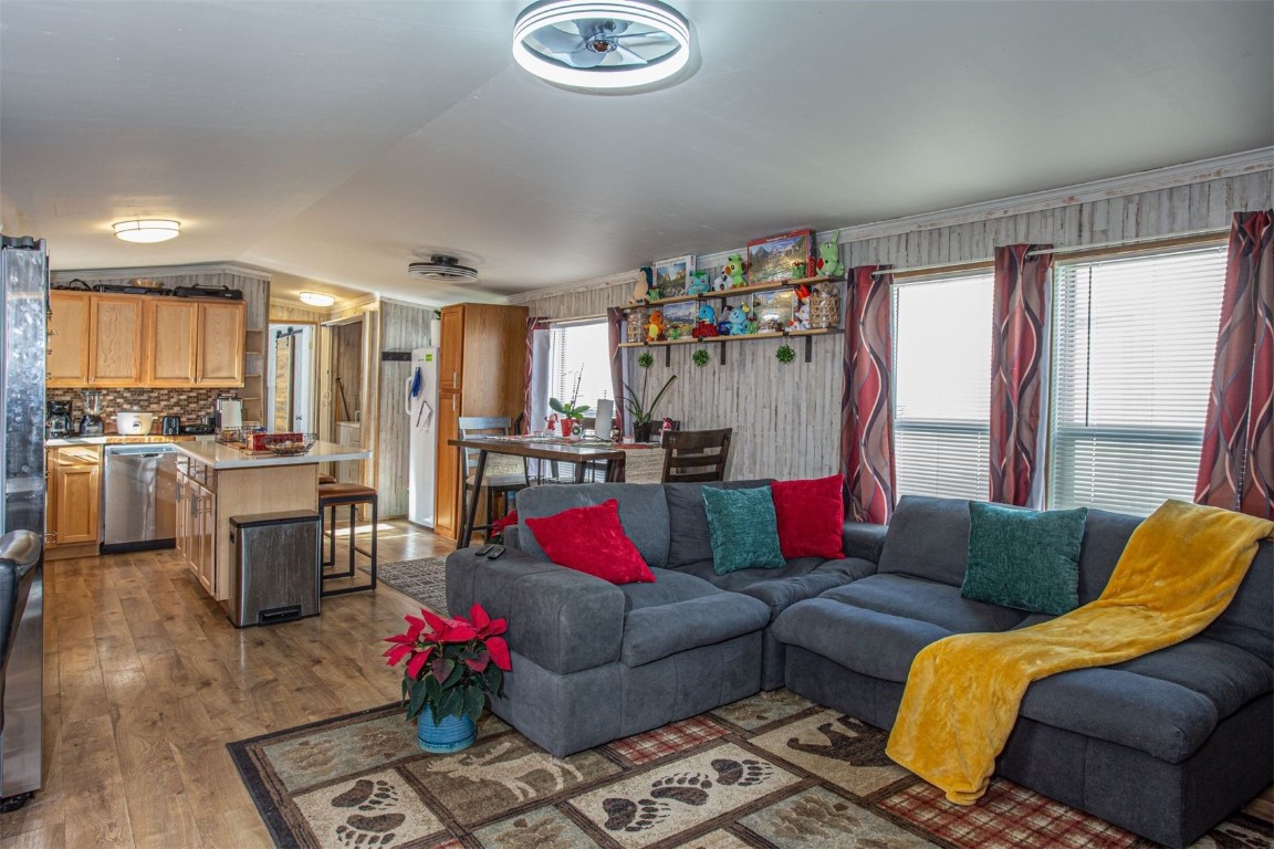 Living room with lofted ceiling and wood-type flooring