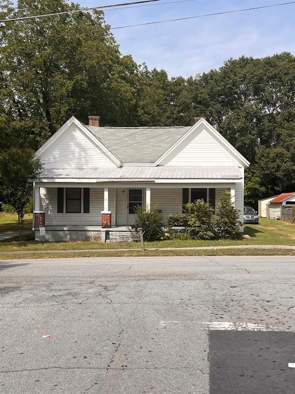 a front view of a house with a yard table and chairs