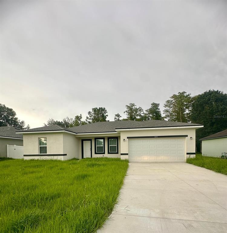 a front view of house with yard and green space