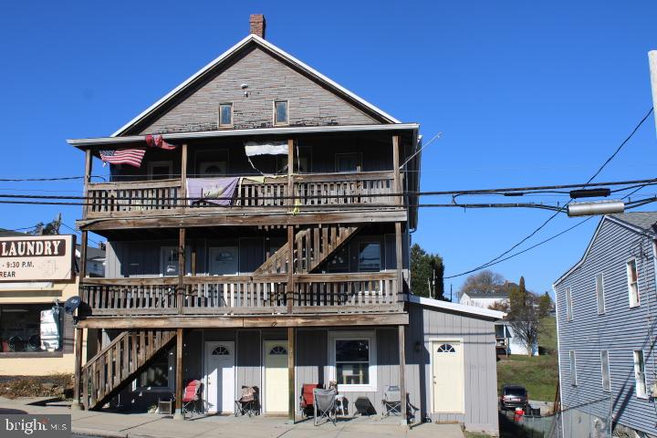 a view of a house with large windows and a small yard