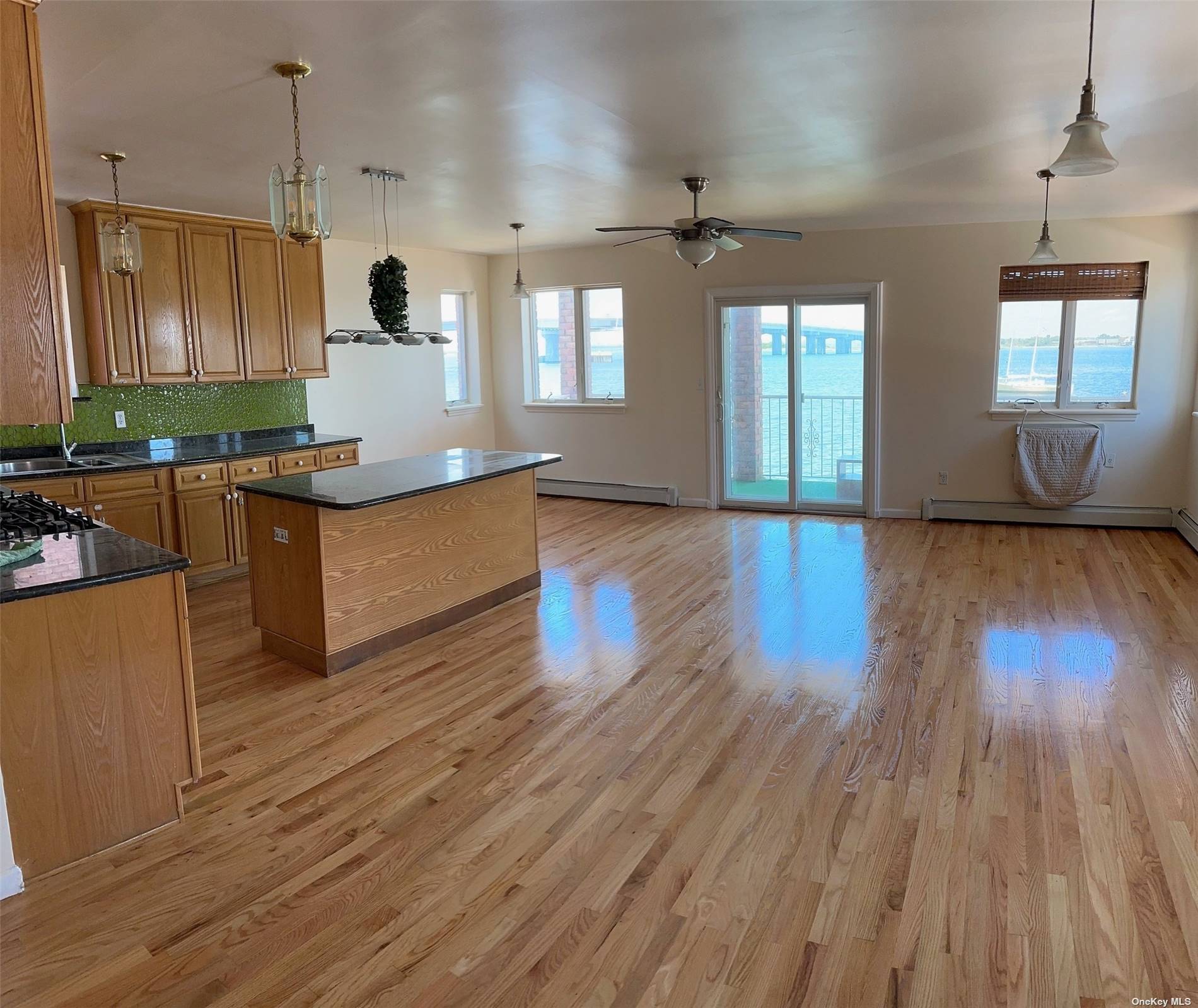 a large kitchen with lots of counter space and wooden floor