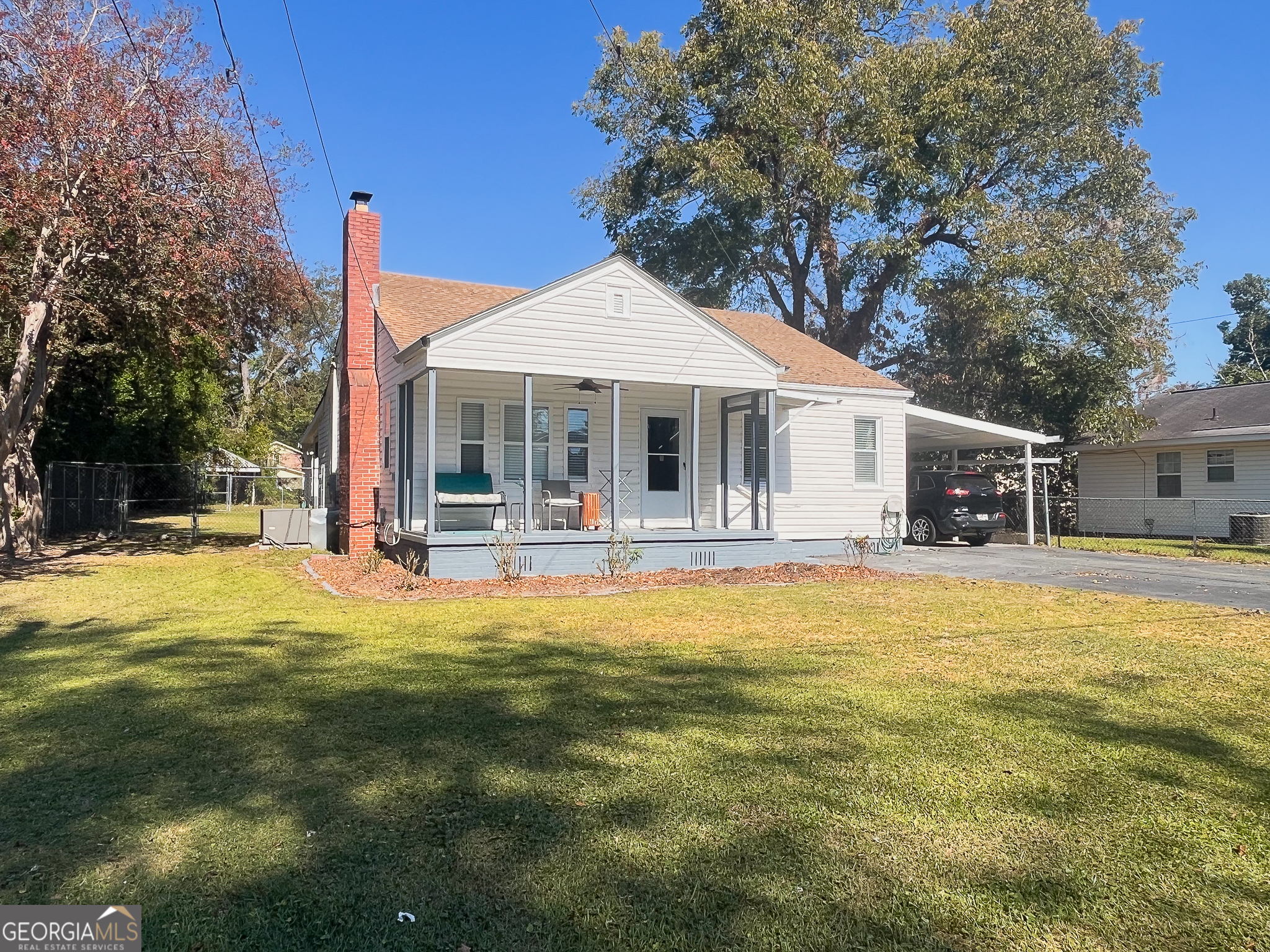 a front view of a house with a yard patio and swimming pool