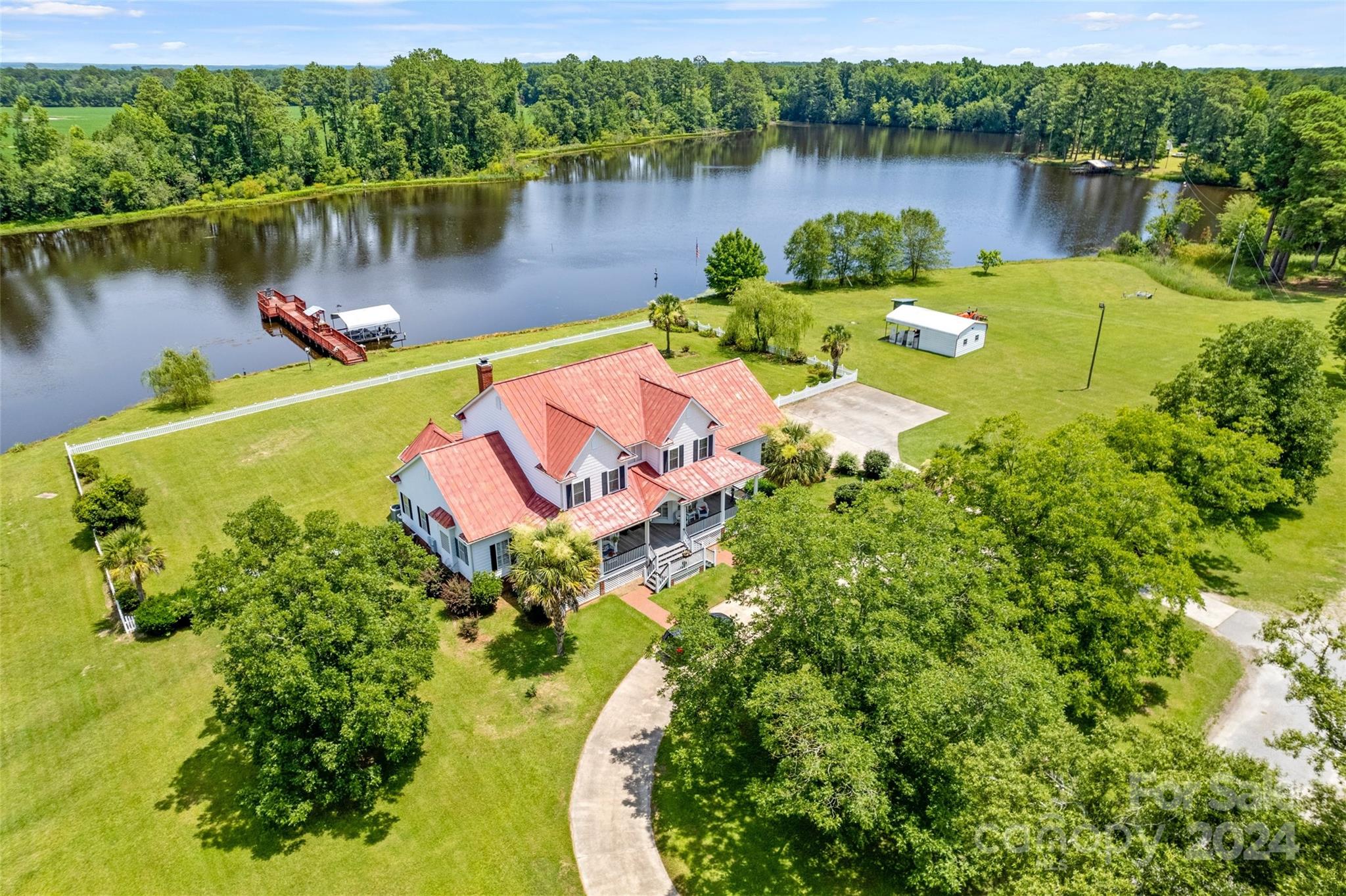 an aerial view of a house with a lake view