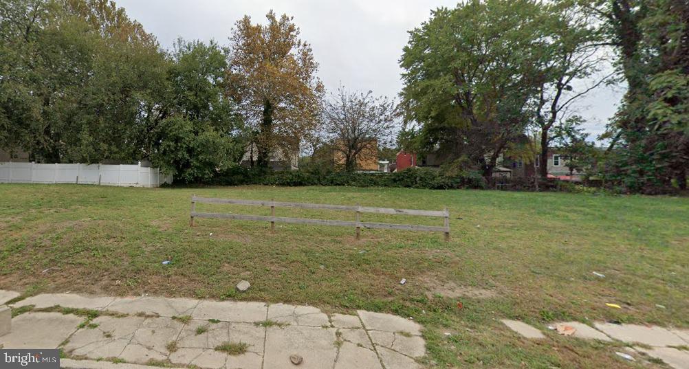 a view of a field with trees in the background