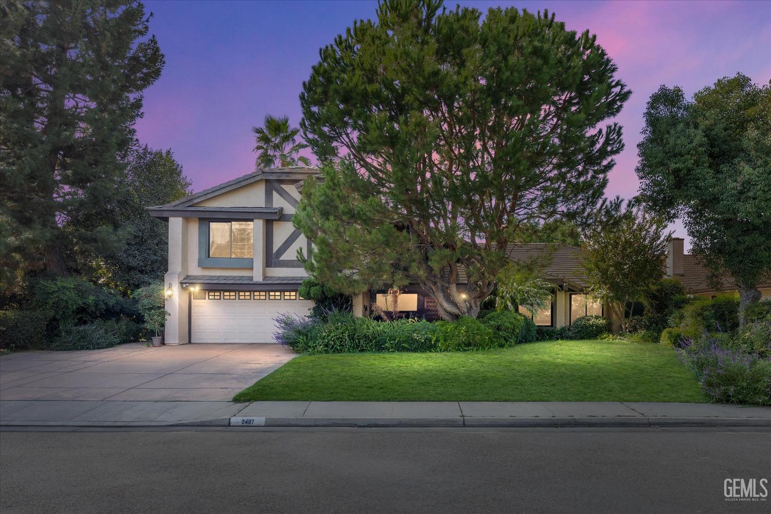 a front view of a house with a yard and a garage