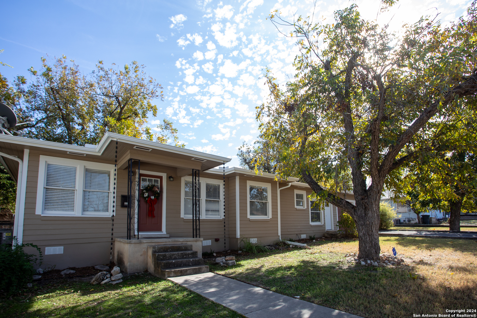 a front view of a house with a yard