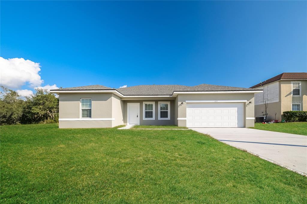 a front view of a house with a yard and garage