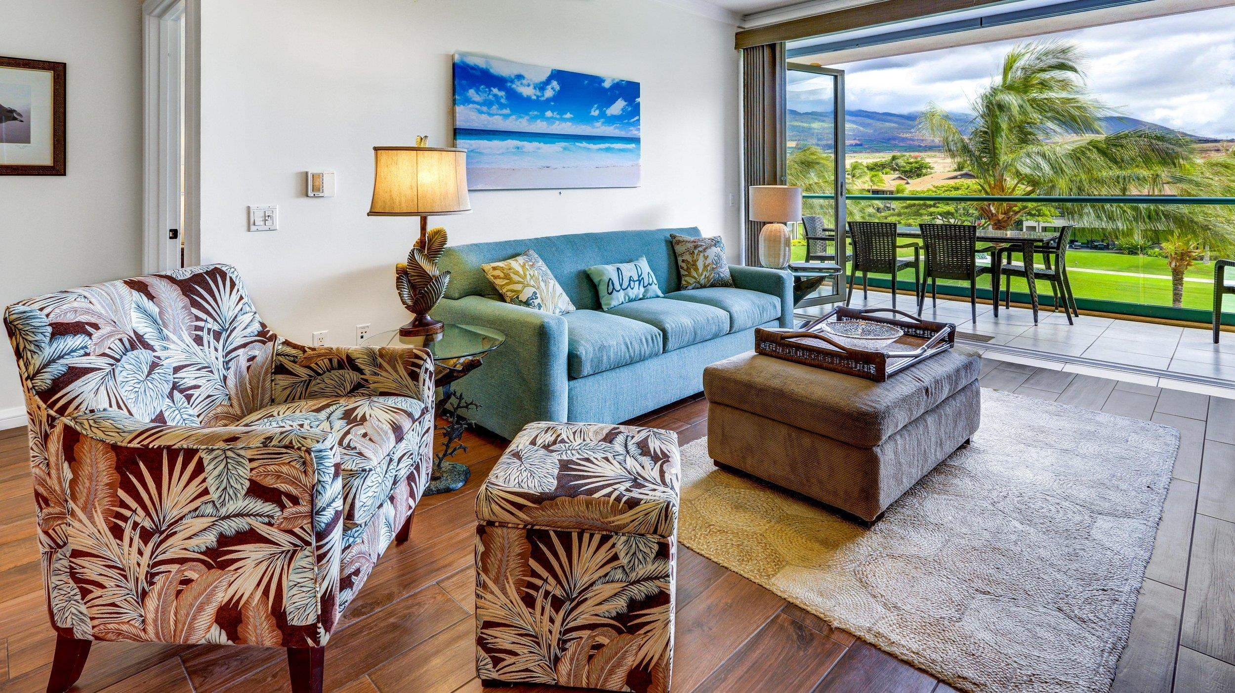 a living room with furniture and a floor to ceiling window