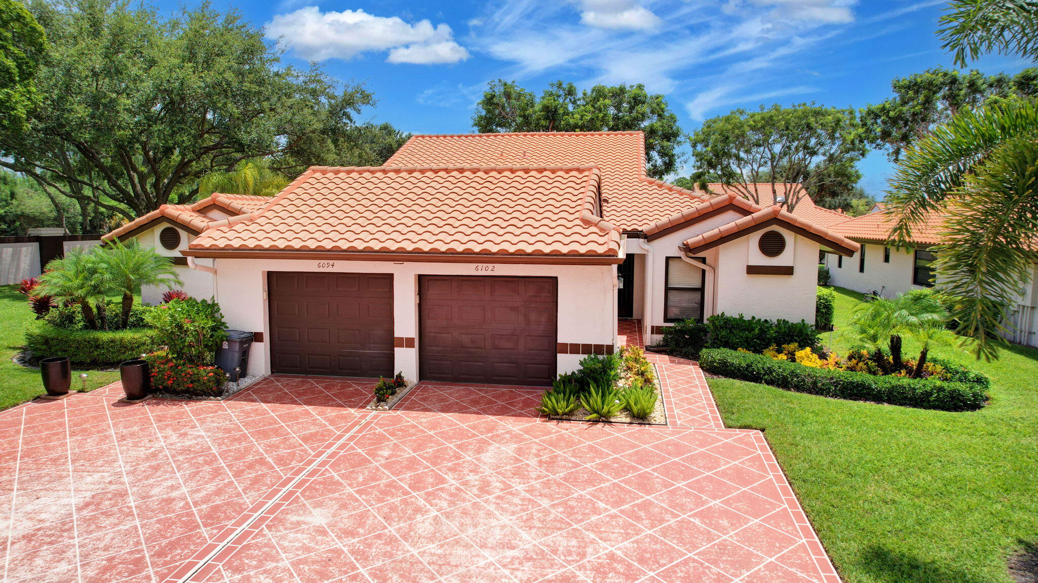 a front view of a house with garden