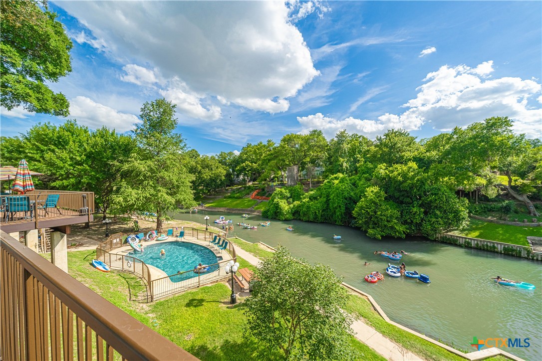 a view of a swimming pool with a yard