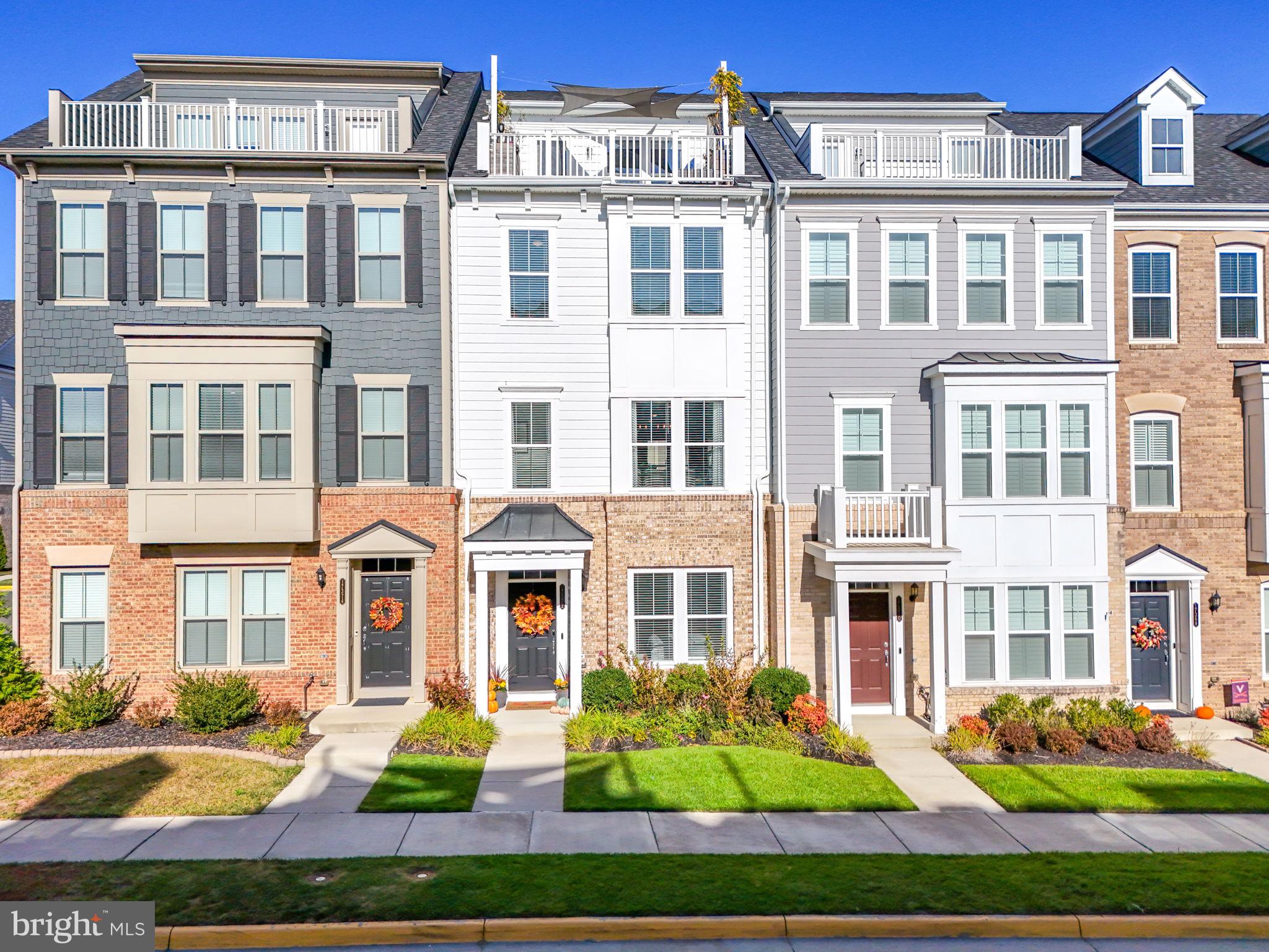 a front view of a residential apartment building with a yard