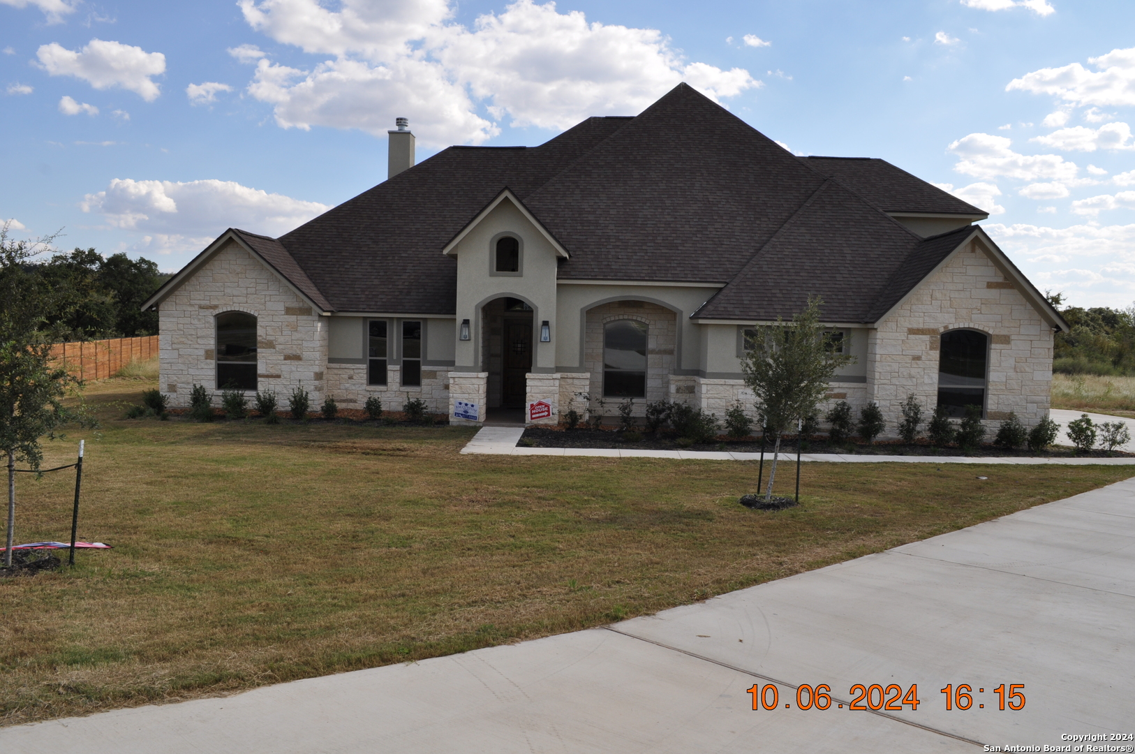 a front view of a house with garden