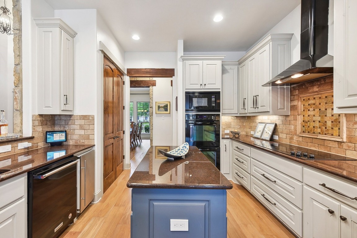 a kitchen with kitchen island granite countertop a sink appliances cabinets and counter space