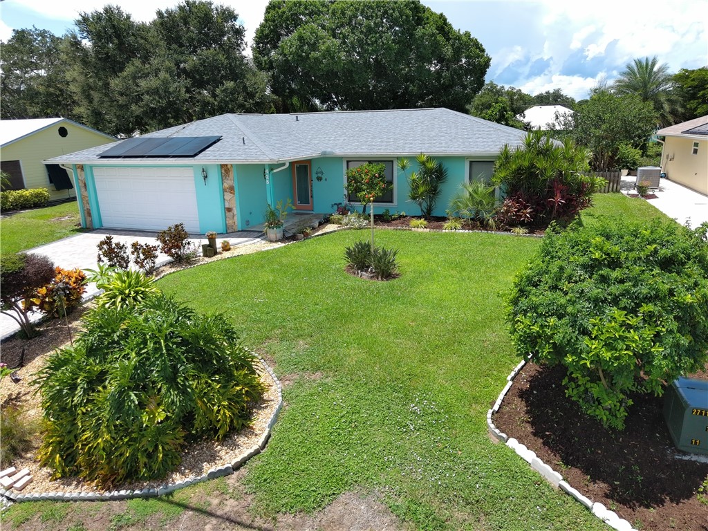 a view of a house with a yard and sitting area