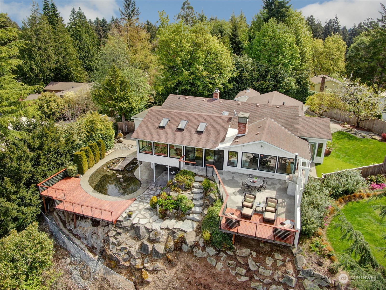 an aerial view of a house with a yard and trees