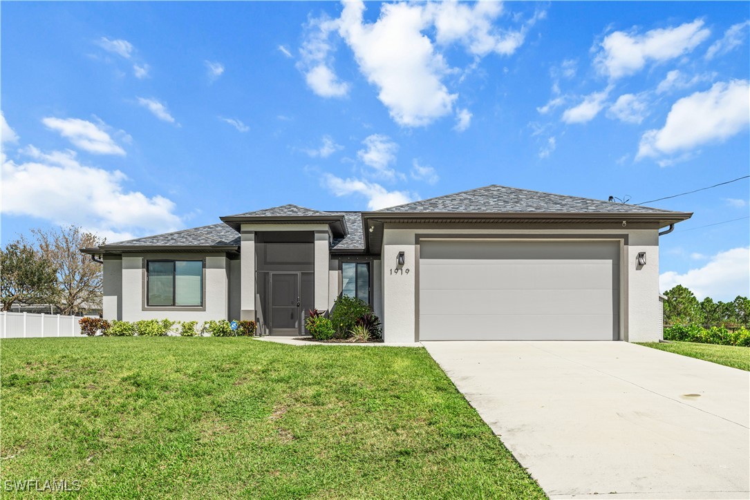 a front view of a house with a yard and garage