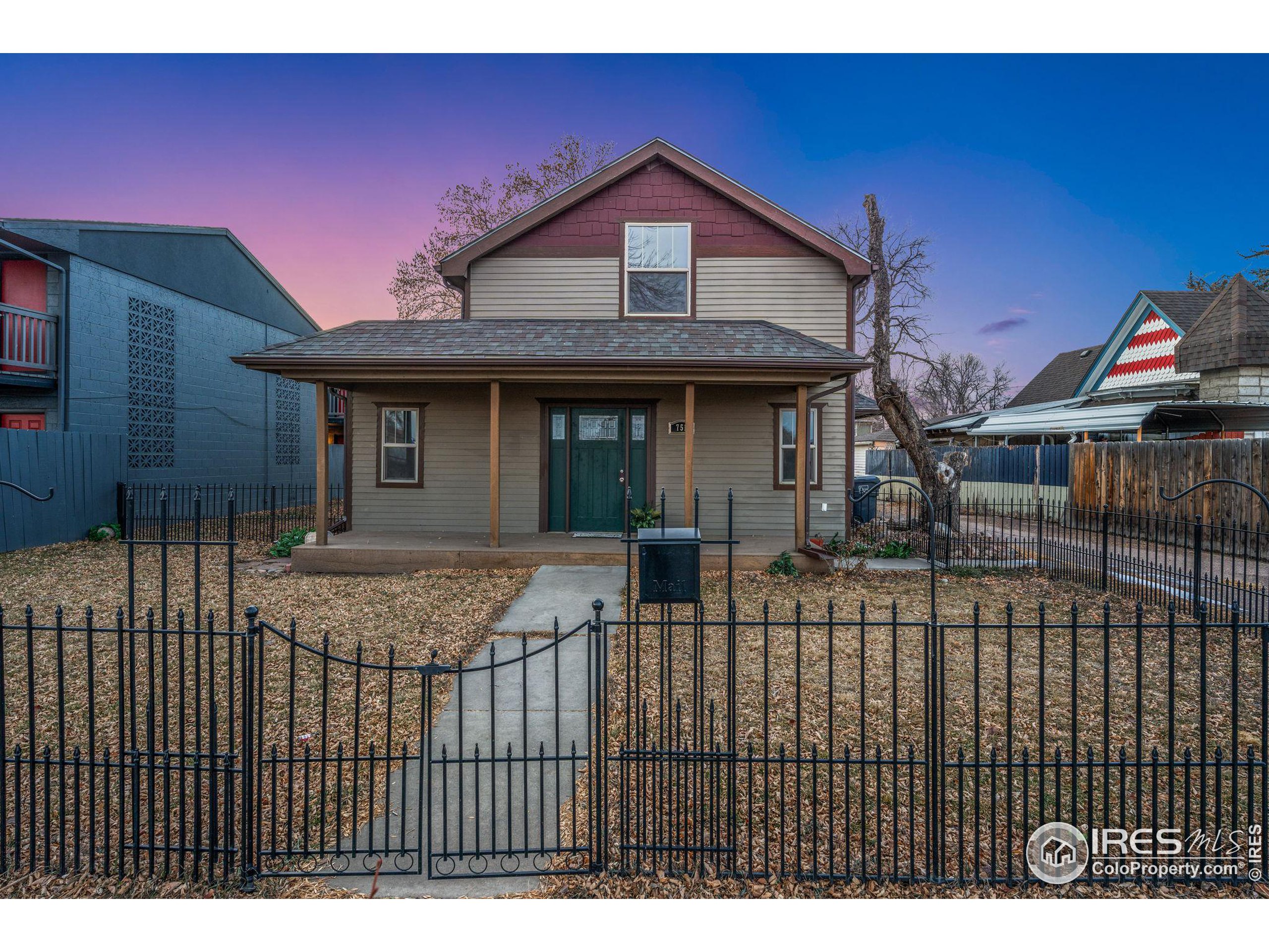 a view of a house with a wooden fence