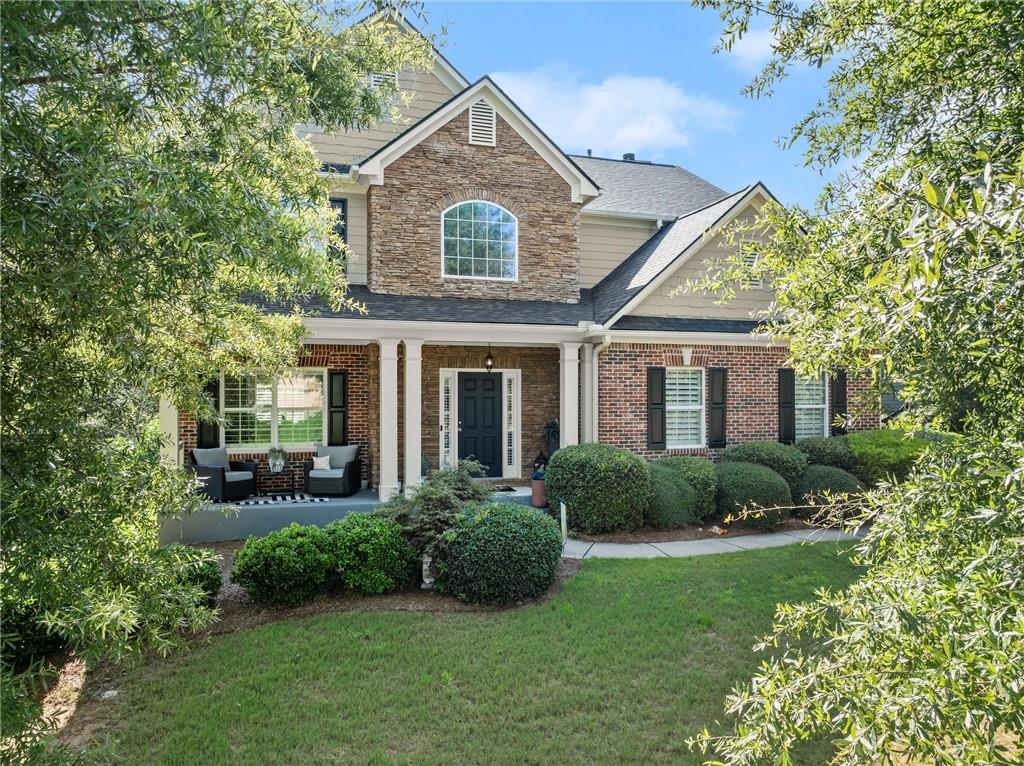 a front view of a house with a yard and outdoor seating