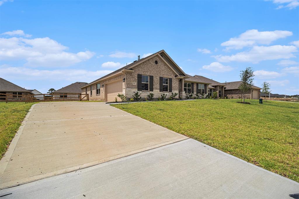 a view of a house with a yard and garage