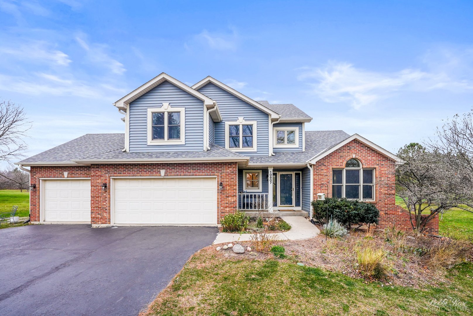 a front view of a house with a yard and garage