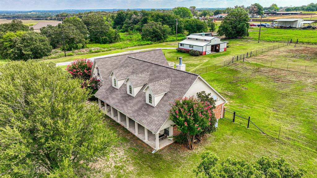 an aerial view of a house with a yard basket ball court and outdoor seating