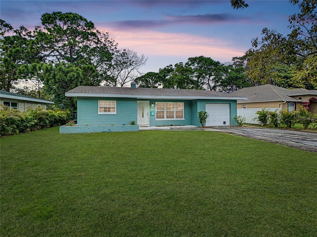 a front view of house with yard and green space