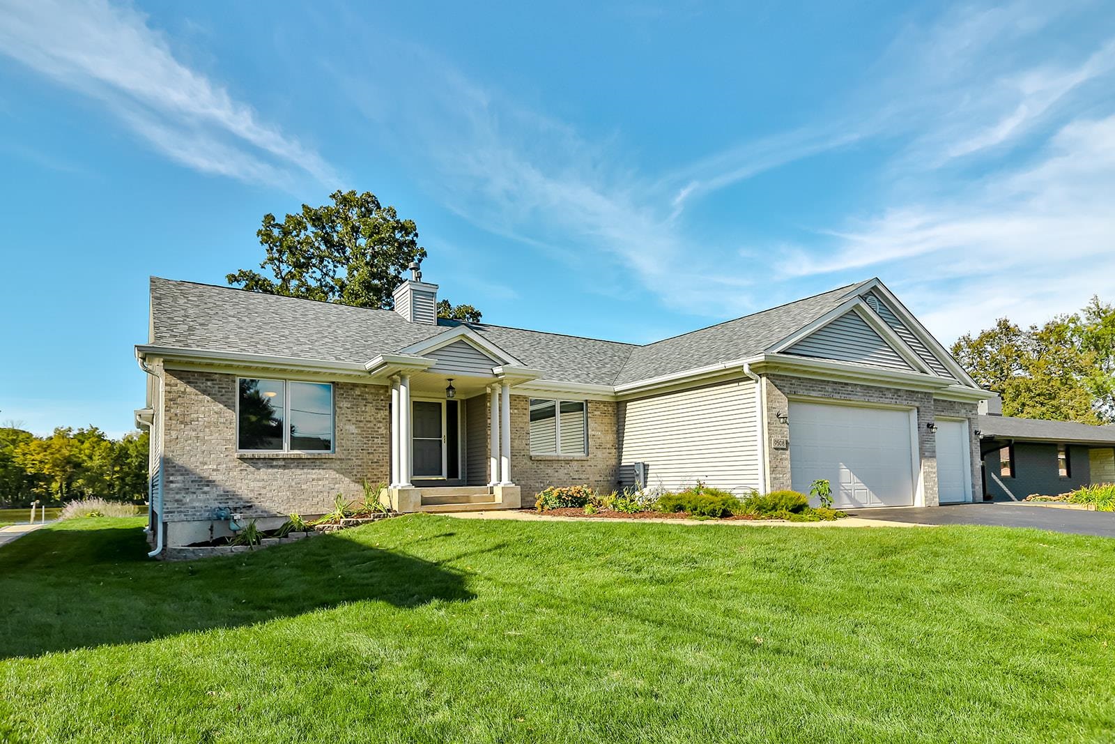 a front view of house with yard and green space