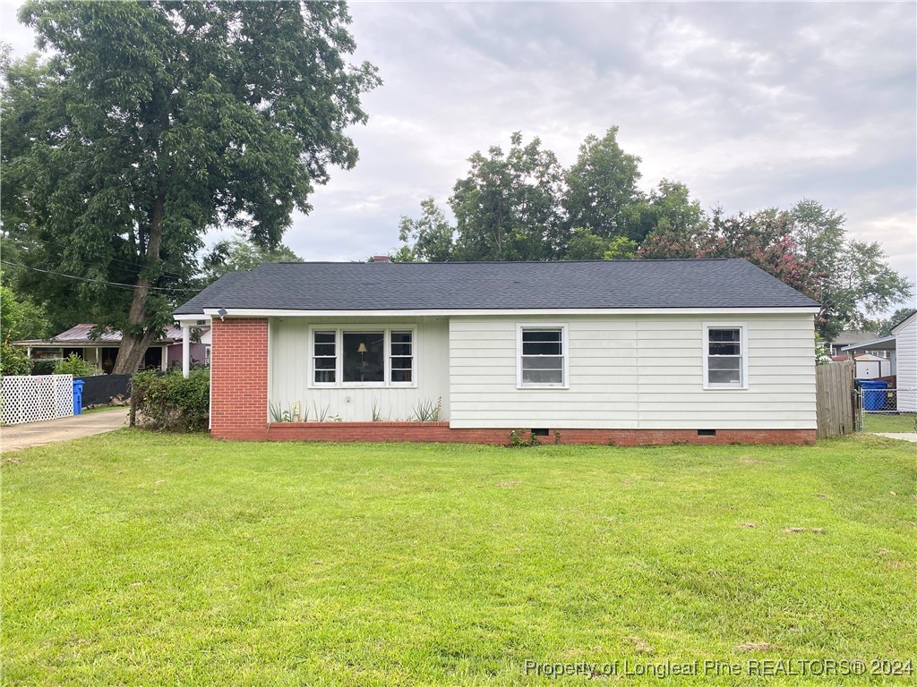 a front view of house with yard and trees