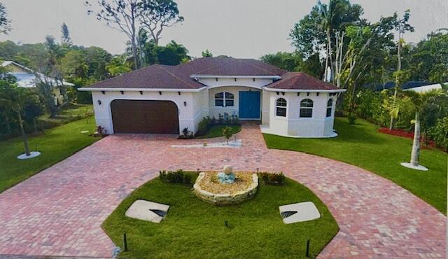 a view of a house with a yard fire pit and outdoor seating